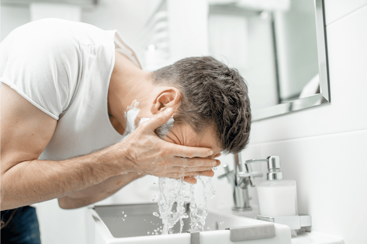 A man rinsing his eyes with water