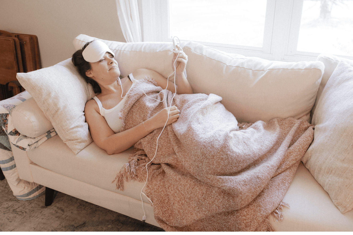 Woman lying down wearing Comfylids heated eye mask